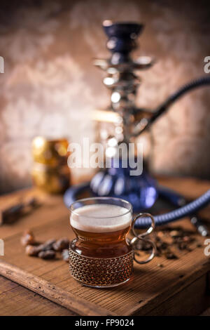 Tea in glass cup with holder on old wooden table Stock Photo