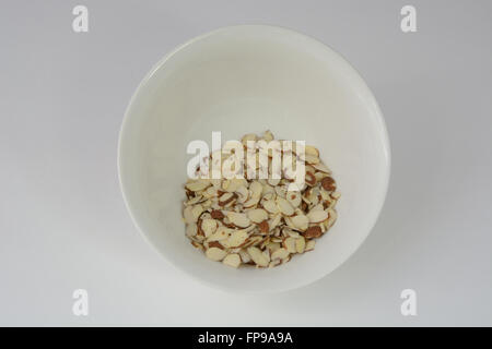 Sliced almonds in white bowl Stock Photo