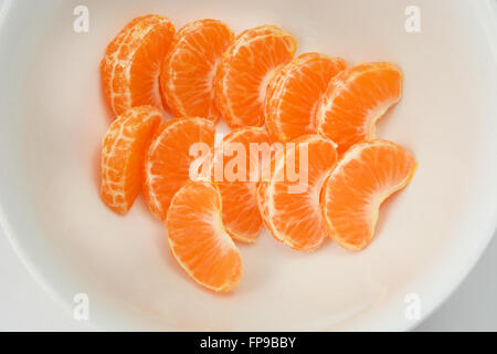 Close up of Mandarin orange slices in white bowl Stock Photo