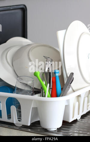 Clean dishes drying on a dish rack Stock Photo