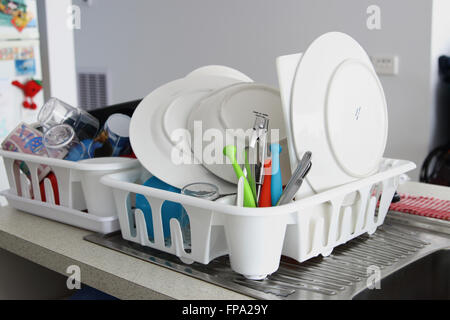 Clean dishes drying on a dish rack Stock Photo