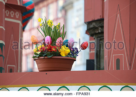 A basket of easter eggs and daffodils sits on a decorated Easter fountain in Coburg, Germany. Each year in the town the local fountains are decorated for the Easter period. Stock Photo