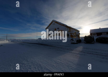 Dyranut Mountain Lodge, the highest on road R7, in Hardangervidda, buried in snow during the winter season. Stock Photo
