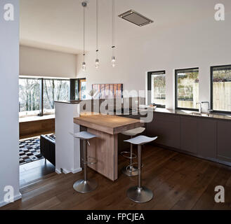 The open plan kitchen and living area of a luxury flat in Ledcamernoch House Glasgow, including and showing how well light from windows has been used. Stock Photo