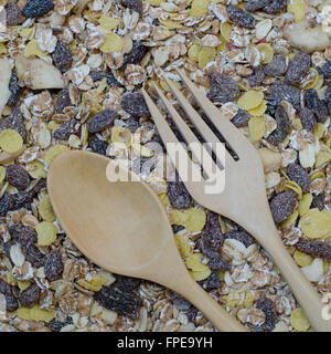 wooden fork and spoon on oat flakes background Stock Photo