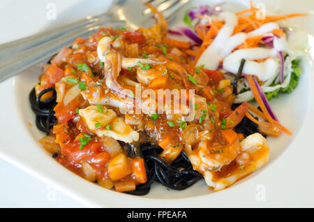 Black spaghetti with seafood on white plate Stock Photo