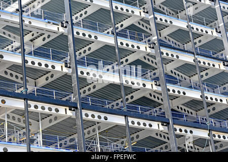 Steel frame multi storey office development showing steel decking & factory made round apertures for routing services & health and safety handrails UK Stock Photo