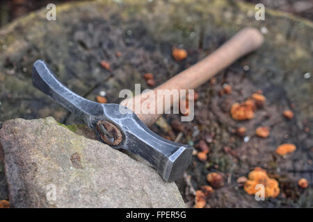 Hand made blacksmith hammer resting on an old stump Stock Photo