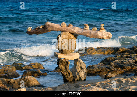 Zen space. Stones. Ses Illetes Beach, Balearic Islands, Formentera, Spain. Backlights in the sunset with stones with different shapes. 'The Flood' ('La Riada'), a unique space built with stones by the German Johannes Schultz. Stock Photo