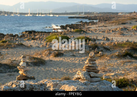 Zen space. Stones. Ses Illetes Beach, Balearic Islands, Formentera, Spain. Backlights in the sunset with stones with different shapes. 'The Flood' ('La Riada'), a unique space built with stones by the German Johannes Schultz. Stock Photo