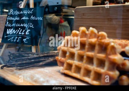 A showcase of a bakery with vanille wafles advertisement, Brussels, Belgium. Another Belgian waffles are typical sweets. There a Stock Photo