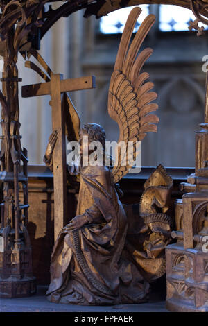 Angel holding the Holy Cross. Detail of the Holy Blood Altarpiece (1500-1505) by German sculptor Tilman Riemenschneider in Saint James' Church in Rothenburg ob der Tauber, Middle Franconia, Bavaria, Germany. Stock Photo