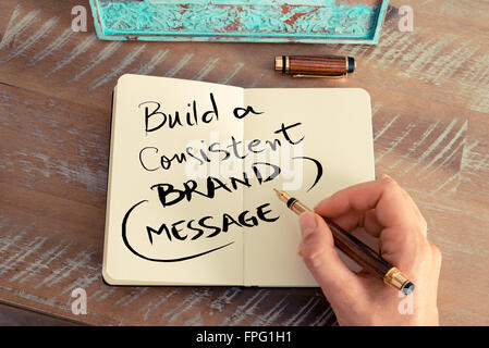 Handwritten text BUILD A CONSISTENT BRAND MESSAGE, business success concept Stock Photo