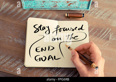 Handwritten text STAY FOCUSED ON THE END GOAL, business success concept Stock Photo