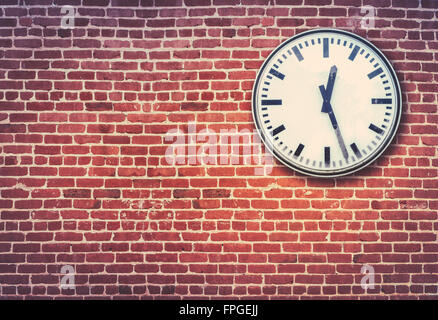 Retro Railway Style Clock Against A Red Brick Wall Stock Photo