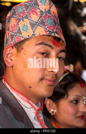 Nepal, Patan. Groom at Wedding Ceremony in Golden Temple, wearing dhaka topi (traditional Nepalese hat) and a  tika on forehead. Stock Photo