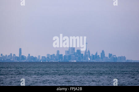 Hazy skyline of Toronto, Ontario, Canada, from across water. Stock Photo