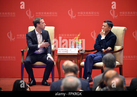 Beijing, China. 19th Mar, 2016. Mark Zuckerberg (L), co-founder and CEO of Facebook, and Jack Ma, founder and board chairman of Alibaba Group, hold a conversation during the Economic Summit of China Development Forum 2016 in Beijing, capital of China, March 19, 2016. Credit:  Li Xin/Xinhua/Alamy Live News Stock Photo
