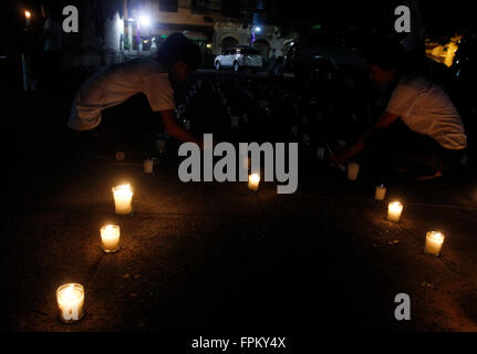 Manila, Philippines. 19th Mar, 2016. Filipino teenagers in Manila participate in candle lighting and praying activity at San Agustin Church as the lights switch-off for Earth Hour 2016. Earth Hour is a worldwide event organized by World Wildlife Fund for Nature that encourage people, communities and businesses to an hour lights-off as a contribution to stop climate change. © Marlo Cueto/Pacific Press/Alamy Live News Stock Photo