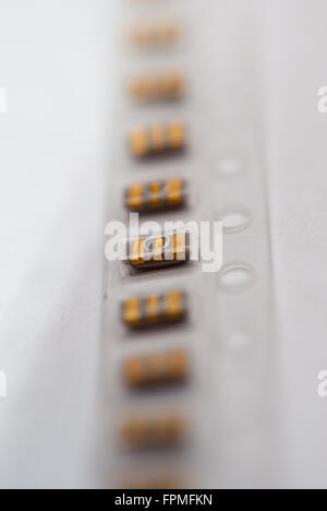 Package of smd capacitors (Murata brand) on a white background closeup. Stock Photo
