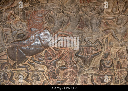 Angkhor Wat, Cambodia - January 29 2016:  Bas relief showing the  furious battle of Kurushetra with a horse rearing up and a car Stock Photo