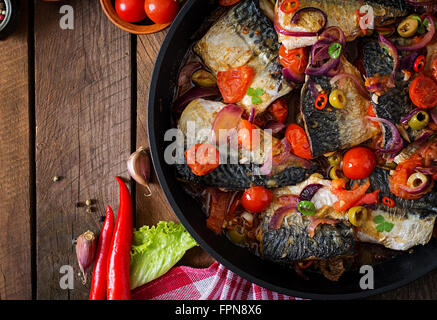 Grilled mackerel with vegetables in Mediterranean style. Stock Photo