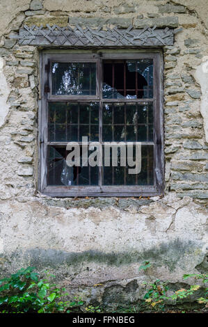 Window in old abandoned house with broken glass Stock Photo