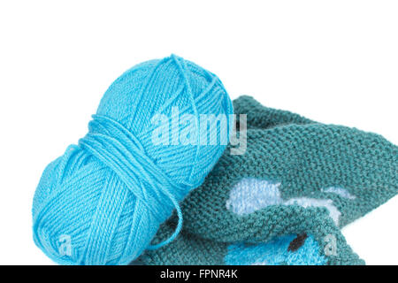 Blue knitting yarn and knitted piece of patterned sweater isolated on the white background. Stock Photo