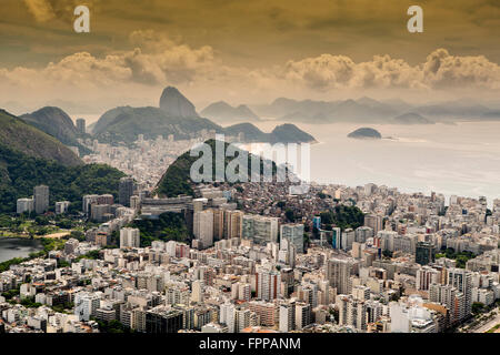 Rio de Janeiro skyline with Sugar Loaf mountain, the Ipanema, Copacabana neighborhoods, favela slums around the hills and the Atlantic Ocean,  Brazil Stock Photo