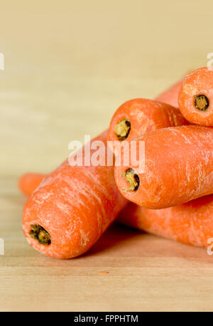 Pile of carrots on chopping board Stock Photo
