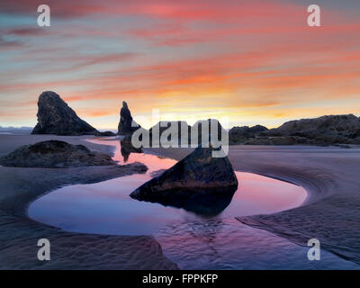 Low tide pools and seastacks reflecting sunrise. Bandon Beach. Oregon Stock Photo