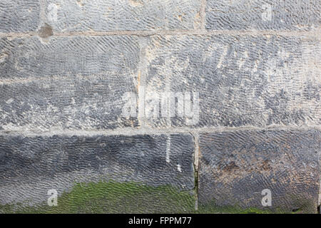 Stone wall with moss growing Stock Photo