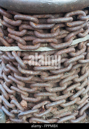 Old metal chain used to anchor boats to harbor Stock Photo