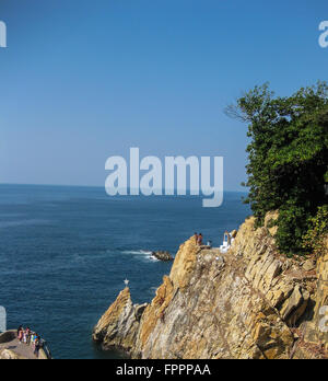 Acapulco, Mexico: Cliff divers prepare to perform and jump off the cliffs into the Pacific Ocean. Stock Photo