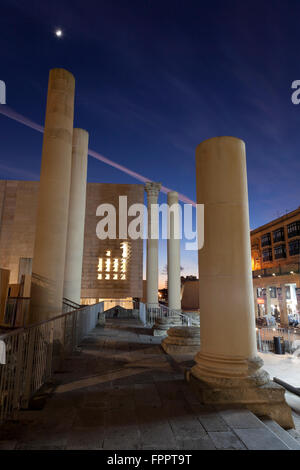 Columns of the former Royal Opera House ruined in World War II are now part of a stupendous architectural setpiece in Valletta. Stock Photo