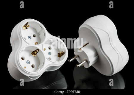 Triple electrical plug outlet on black background Stock Photo
