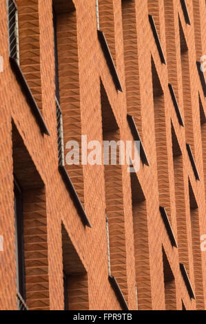 Orange brick wall with windows of modern building, abstract view Stock Photo
