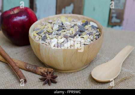 Oat flakes in wooden bolw Stock Photo