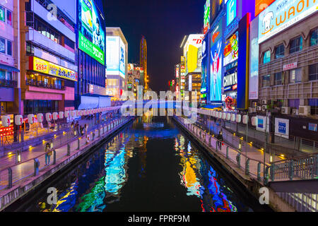 Bright illuminated signs on banks of Dotonbori canal at night in Namba district of Osaka, Japan. Horizontal Stock Photo
