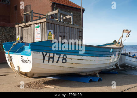 Boats on the slip way to the sea at Sheringham Stock Photo