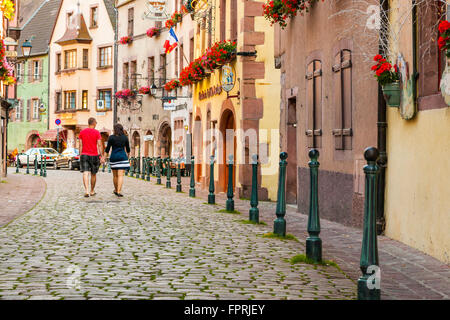 Two tourist walking along the route of Kaysersberg Alsace Haut Rhin France Stock Photo