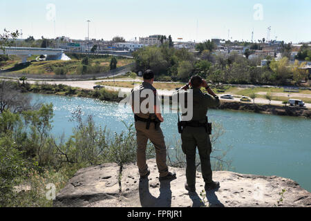 Border Patrol Agent and Texas Department of Public Safety officer observe activity in the city of Miguel Aleman. Stock Photo