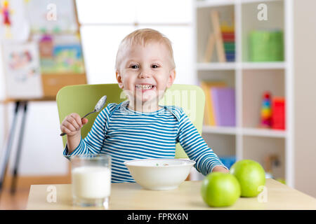 kid eating healthy food at home or kindergarten Stock Photo