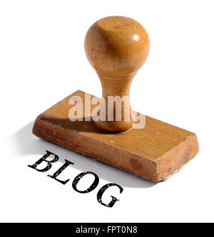Single old fashioned wooden rubber stamp with drop shadow and blog text over white background Stock Photo