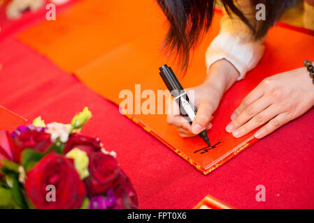 guests signing on the guestbook in a wedding Stock Photo