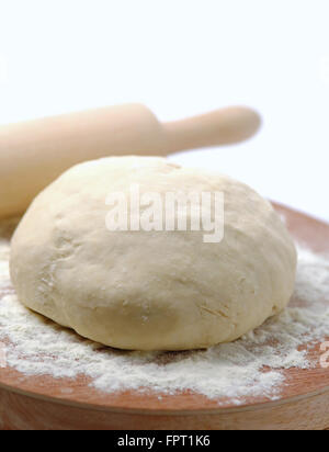 Dough pizza with rolling pin Stock Photo