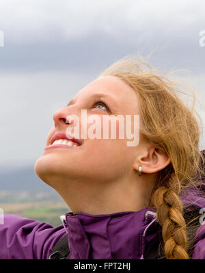 Young happy woman looking in to the sky Stock Photo