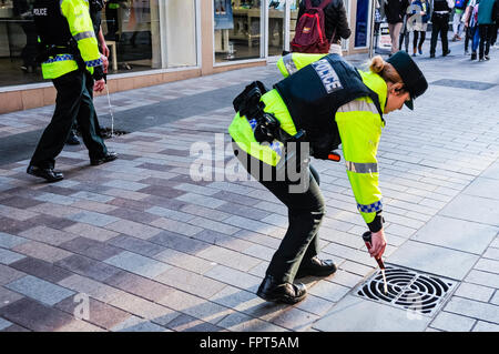 Belfast, Northern Ireland. 17 Mar 2016 - PSNI police officers dispose of alcohol confiscated from youths. Stock Photo