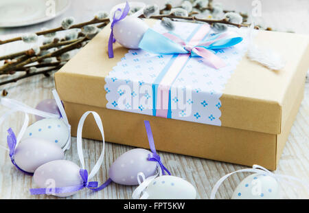 Easter gift with Easter eggs decoration and spring buds branches Stock Photo