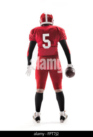 The back view of caucasian fitness man as american football player holding a ball on white background Stock Photo